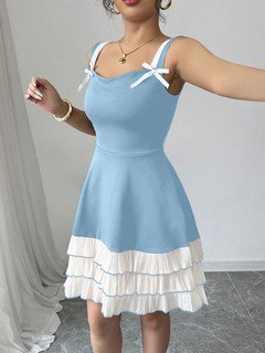 Styled front view of the blue and white bow-strap tiered ruffle dress, showing its silhouette and design details.