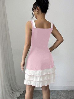 Back view of the pink and white bow-strap tiered ruffle dress, showing its silhouette and design details.