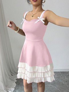 Styled front view of the pink and white bow-strap tiered ruffle dress, showing its silhouette and design details.