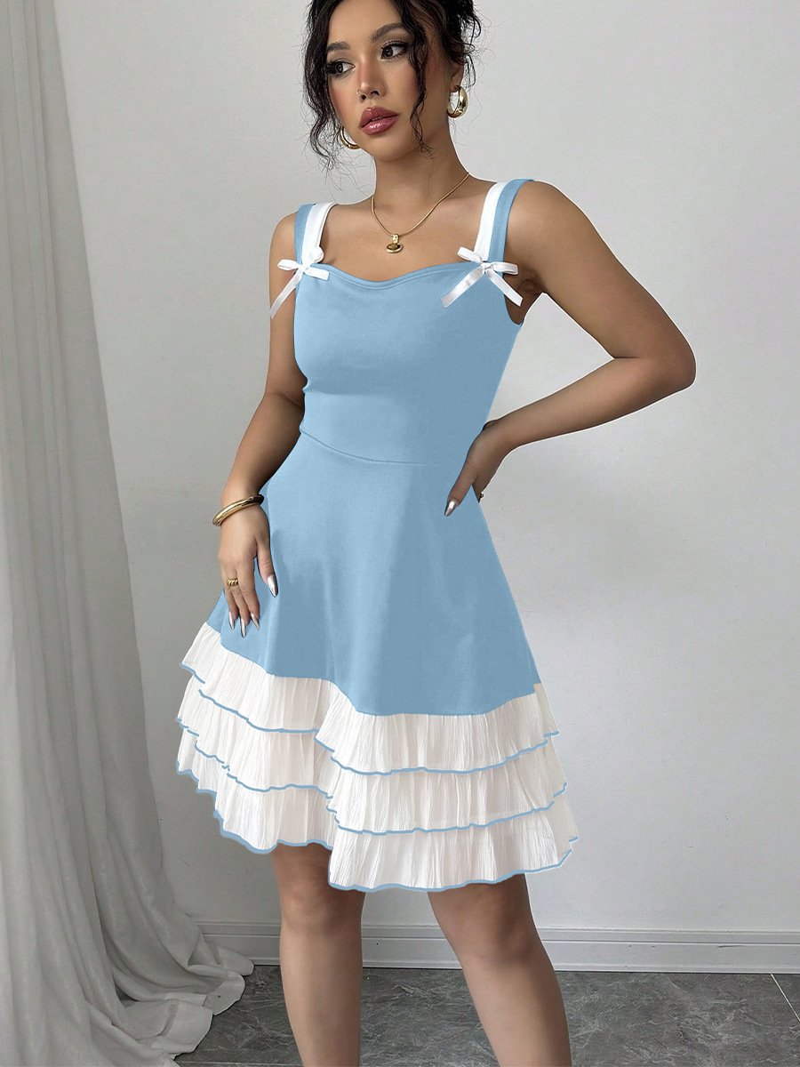 A blue and white bow-strap tiered ruffle dress photographed full length