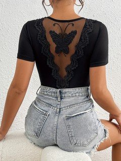 Styled back view of the black butterfly lace-back short-sleeve bodysuit, showing the silhouette and fit.