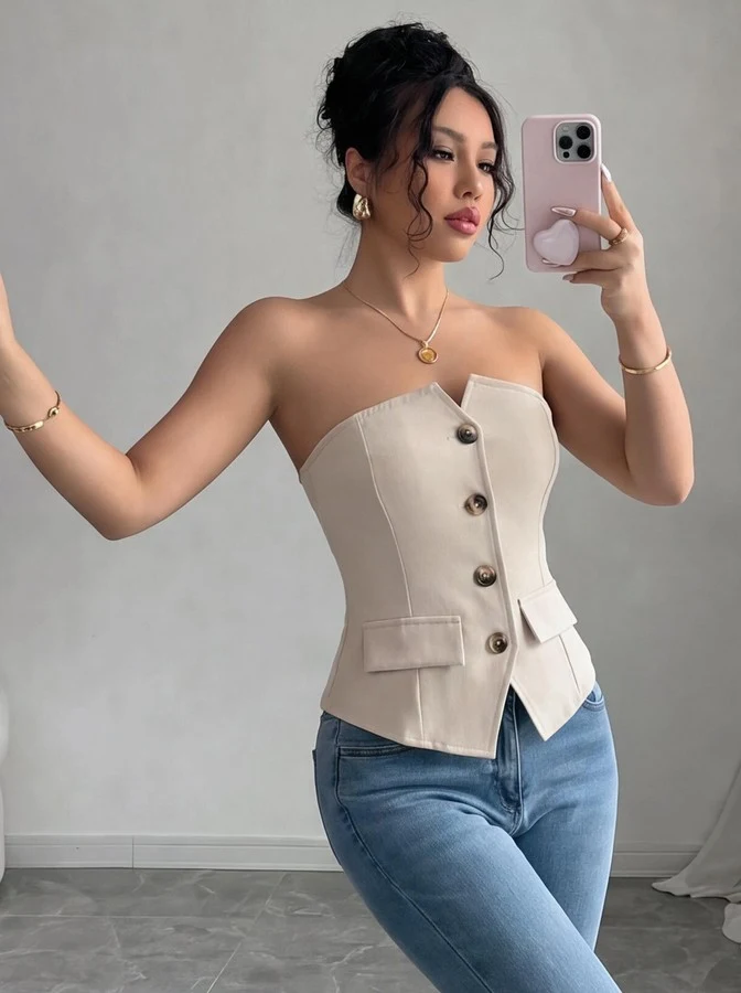 Angled front view of the beige button-front strapless tailored corset top, showing the silhouette and fit.