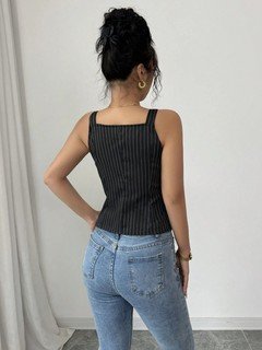 Angled back view of the black button-front v-neck tailored vest, showing its silhouette and design details.