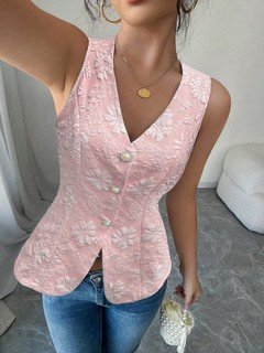 Close-up of the pink button-front v-neck tailored vest, showing its silhouette and design details.