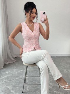 Styled front view of the pink button-front v-neck tailored vest, showing its silhouette and design details.