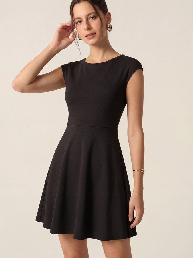 Front view of the black cap-sleeve fit-and-flare dress, showing its silhouette and design details.