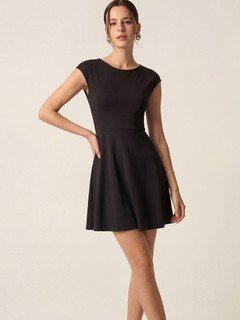 Full-length front view of the black cap-sleeve fit-and-flare dress, showing its silhouette and design details.