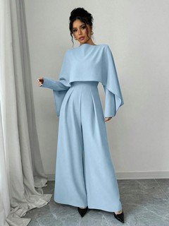 Full length front view of the light blue cape-overlay tie-waist wide-leg jumpsuit, showing the silhouette and fit.