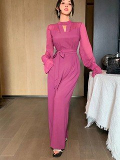 Front view of the magenta cape-sleeve tie-waist wide-leg jumpsuit, showing the silhouette and fit.