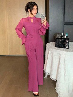 Full length front view of the magenta cape-sleeve tie-waist wide-leg jumpsuit, showing the silhouette and fit.