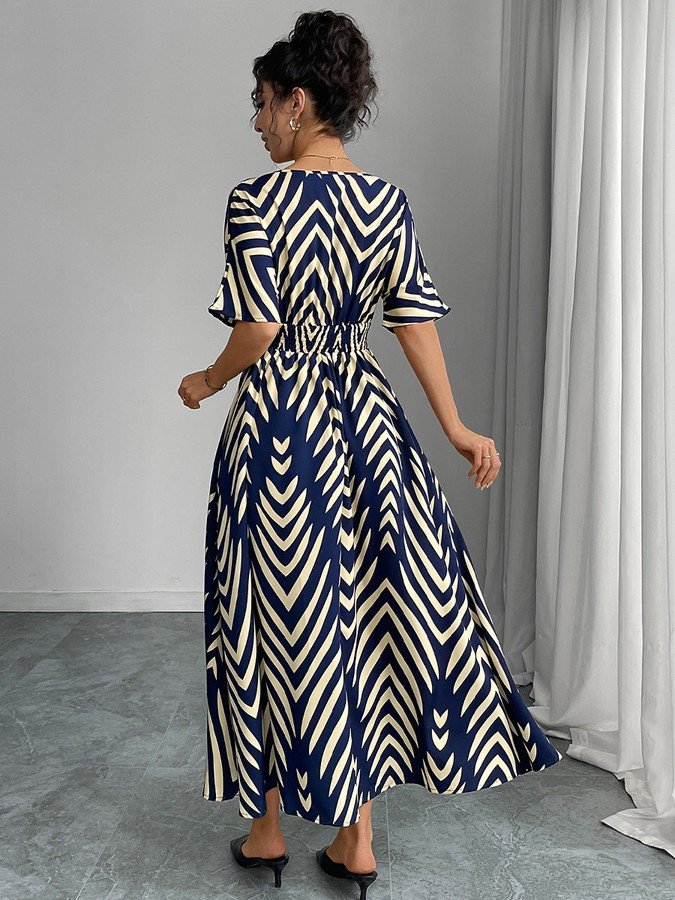 Back view of the navy and cream chevron wrap-front maxi dress, showing its silhouette and design details.