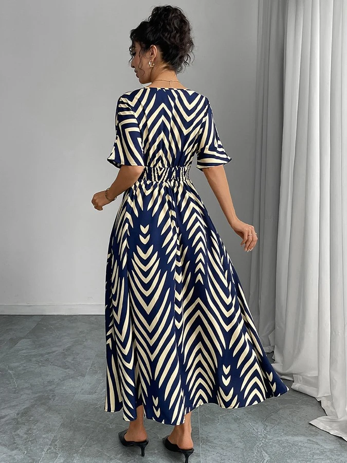 Back view of the navy and cream chevron wrap-front maxi dress, showing its silhouette and design details.