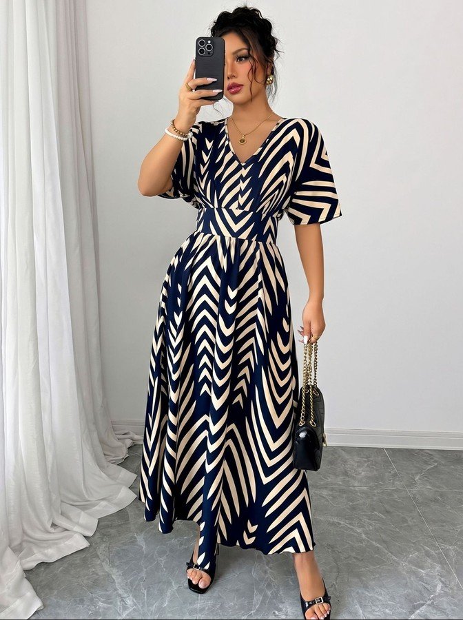 Front view of the navy and cream chevron wrap-front maxi dress, showing its silhouette and design details.