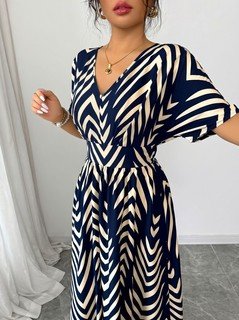 Close-up of the navy and cream chevron wrap-front maxi dress, showing its silhouette and design details.