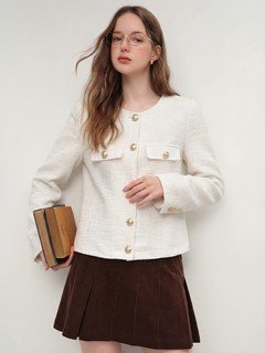 Angled front view of the ivory collarless textured button jacket, showing its silhouette and design details.