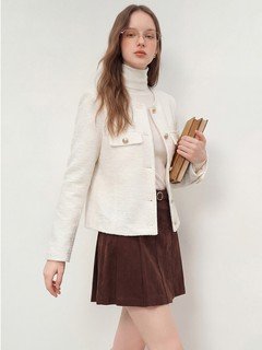 Lifestyle front view of the ivory collarless textured button jacket, showing its silhouette and design details.