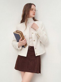 Styled front view of the ivory collarless textured button jacket, showing its silhouette and design details.