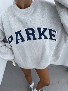 Close-up of the gray collegiate oversized sweatshirt, showing its silhouette and design details.