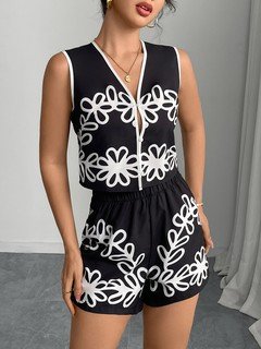Front view of the black and white embroidered vest and shorts set, showing its silhouette and design details.