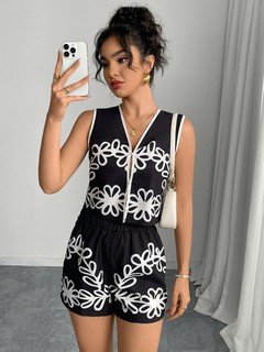 Full-length front view of the black and white embroidered vest and shorts set, showing its silhouette and design details.