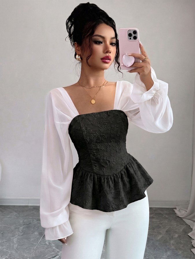 Front view of the black contrast mesh puff-sleeve corset peplum top, showing the silhouette and fit.