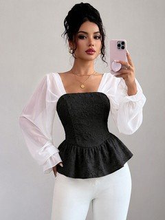Angled front view of the black contrast mesh puff-sleeve corset peplum top, showing the silhouette and fit.