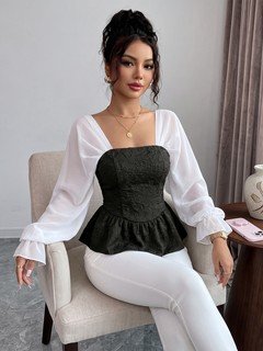 Seated front view of the black contrast mesh puff-sleeve corset peplum top, showing the silhouette and fit.