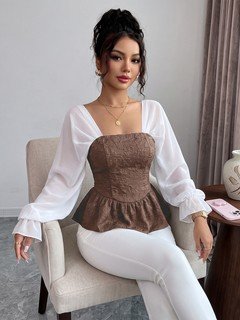 Seated front view of the brown contrast mesh puff-sleeve corset peplum top, showing the silhouette and fit.