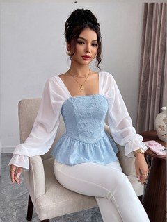 Seated front view of the light blue contrast mesh puff-sleeve corset peplum top, showing the silhouette and fit.
