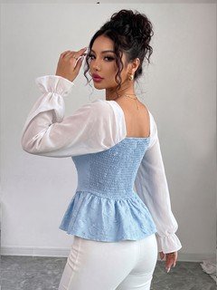 Side view of the light blue contrast mesh puff-sleeve corset peplum top, showing the silhouette and fit.
