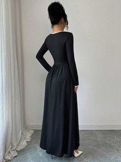 Back view of the black contrast-piping square-neck long-sleeve maxi dress, showing the silhouette and fit.