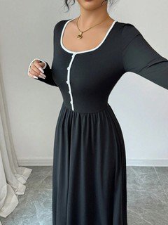 Bodice detail of the black contrast-piping square-neck long-sleeve maxi dress, showing square neckline, contrast piping and flowing skirt.