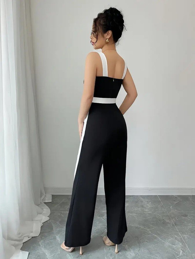 Back view of the black and white contrast-trim wide-leg jumpsuit, showing its silhouette and design details.
