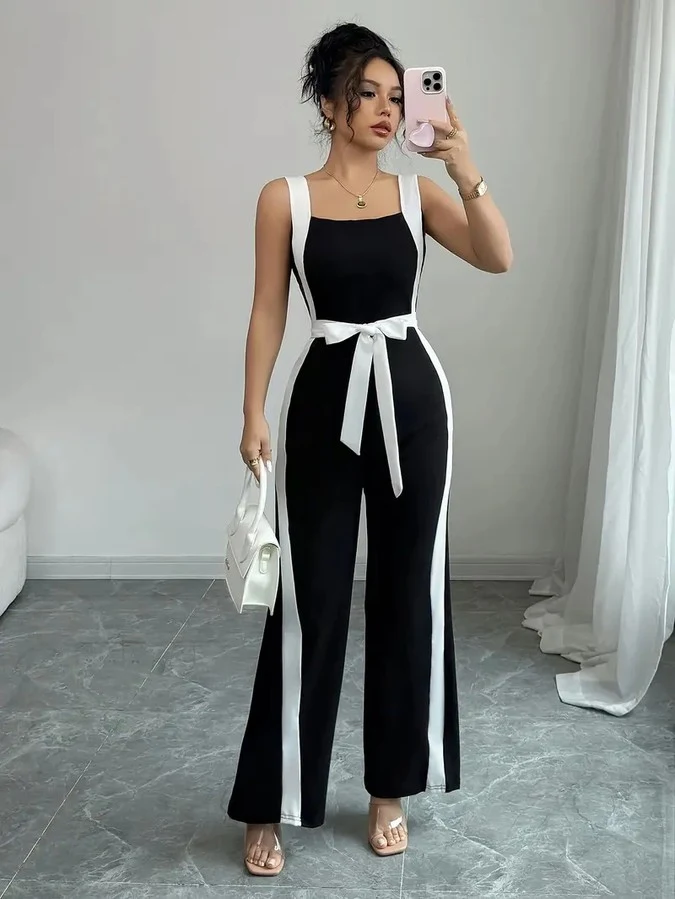 Front view of the black and white contrast-trim wide-leg jumpsuit, showing its silhouette and design details.