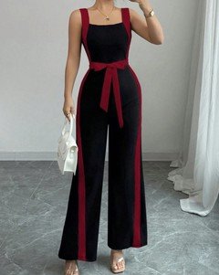 Front view of the black and red contrast-trim wide-leg jumpsuit, showing its silhouette and design details.