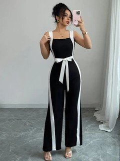 Angled front view of the black and white contrast-trim wide-leg jumpsuit, showing its silhouette and design details.