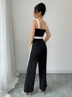 Back view of the black and white contrast-trim wide-leg jumpsuit, showing its silhouette and design details.