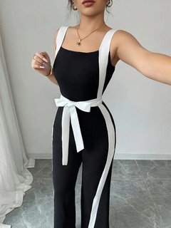 Full-length front view of the black and white contrast-trim wide-leg jumpsuit, showing its silhouette and design details.
