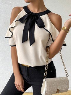 Angled front view of the ivory and black bow-neck cold-shoulder blouse, showing its silhouette and design details.