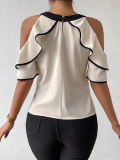 Back view of the ivory and black bow-neck cold-shoulder blouse, showing its silhouette and design details.