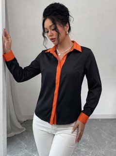 Angled front view of the black contrast-trim long-sleeve button-up shirt, showing the silhouette and fit.