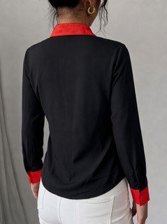 Back view of the black contrast-trim long-sleeve button-up shirt, showing the silhouette and fit.