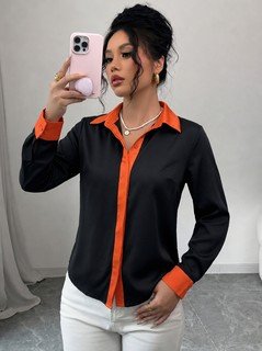Front view of the black contrast-trim long-sleeve button-up shirt, showing the silhouette and fit.