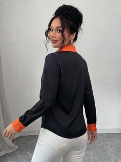 Side view of the black contrast-trim long-sleeve button-up shirt, showing the silhouette and fit.