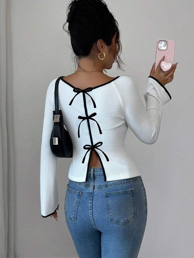 Back view of the white and black bow-back contrast-trim ribbed top, showing its silhouette and design details.
