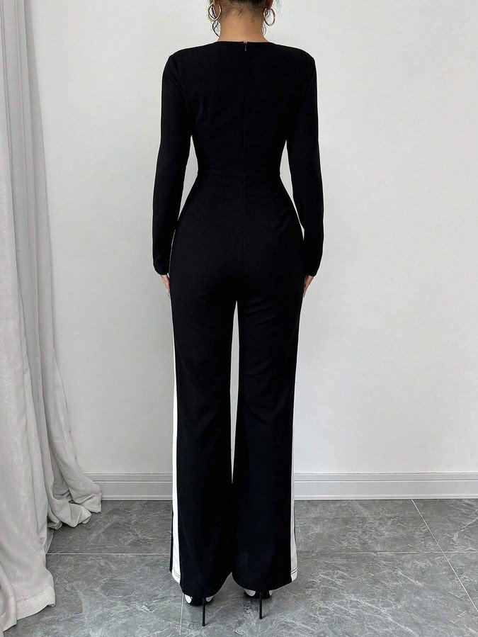 Back view of the black contrast-trim square-neck long-sleeve jumpsuit, showing the silhouette and fit.