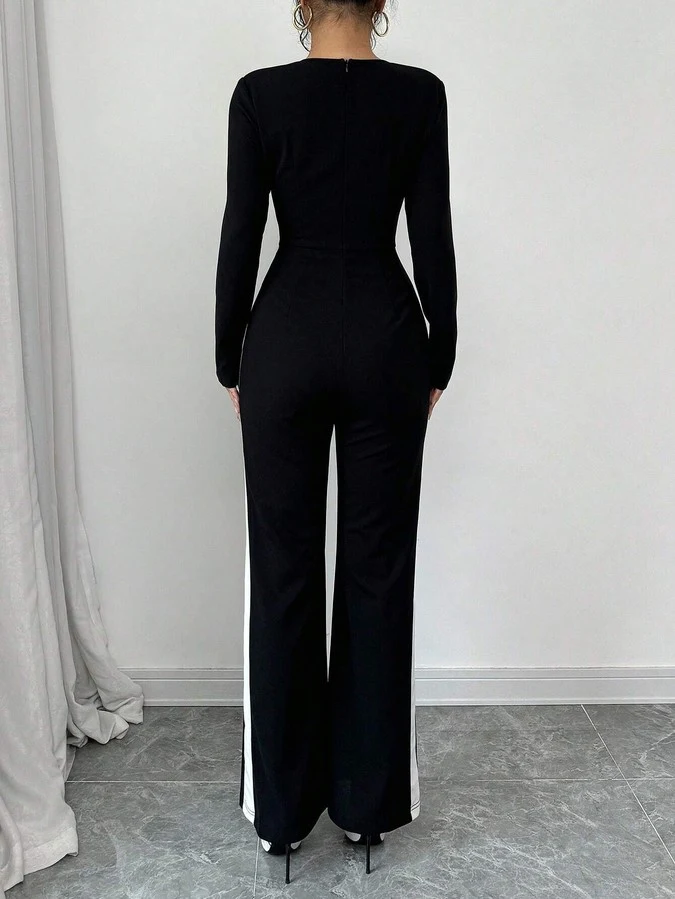 Back view of the black contrast-trim square-neck long-sleeve jumpsuit, showing the silhouette and fit.