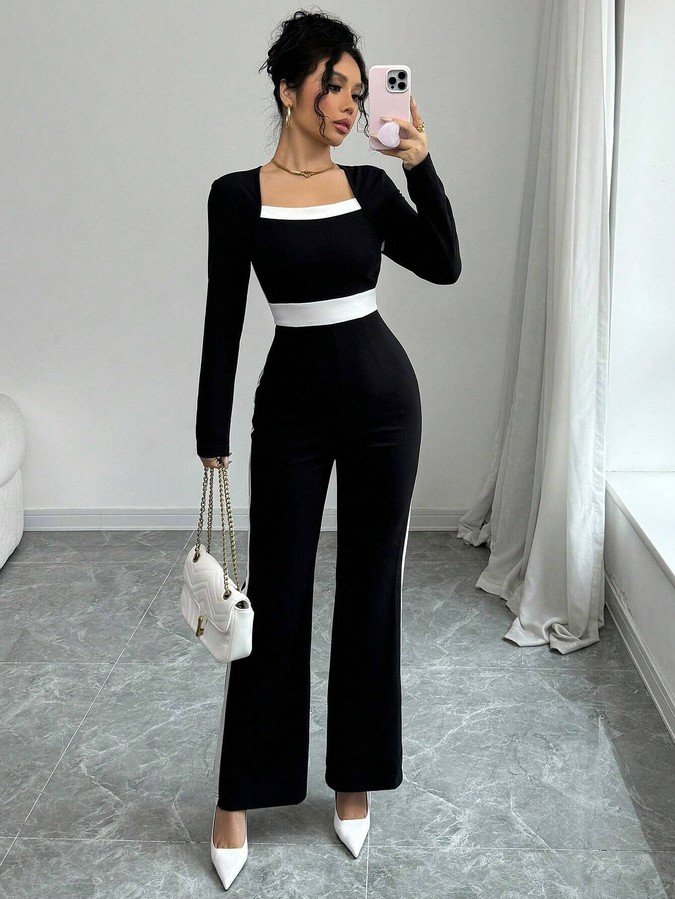 Front view of the black contrast-trim square-neck long-sleeve jumpsuit, showing the silhouette and fit.
