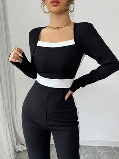Bodice detail of the black contrast-trim square-neck long-sleeve jumpsuit, showing square neckline, contrast trim and wide-leg shape.