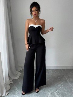 Styled front view of the black contrast-trim strapless peplum top and wide-leg pants set, showing the silhouette and fit.